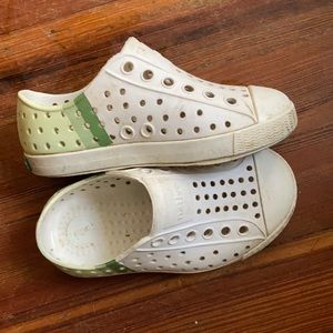 White Native shoes with green stripes